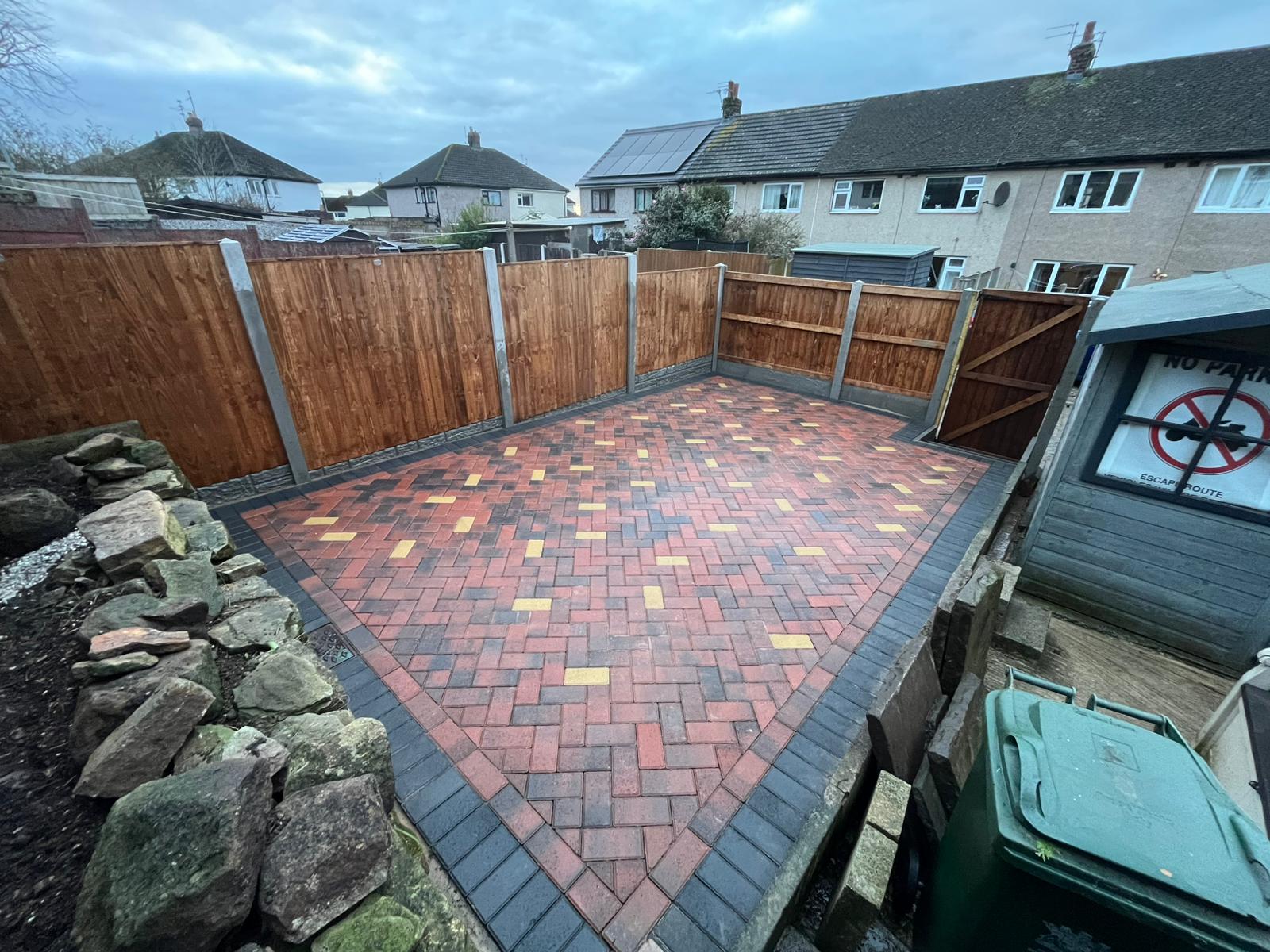 Brindle block paved yard with charcoal border and new fencing